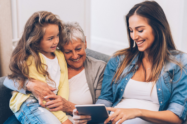 Three Generation women have fun at home with digital tablet